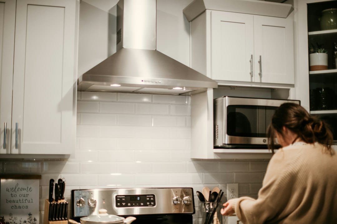 Professional pest control treatment being applied safely in a residential kitchen